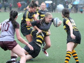 Kaitlin Robinson of the Frontenac Falcons runs against the La Salle Black Knights in the Kingston Area Secondary Schools Athletic Association girls rugby final on a wet Nixon Field in Kingston on Tuesday, June 7, 2022. La Salle won the game, 12-0.
